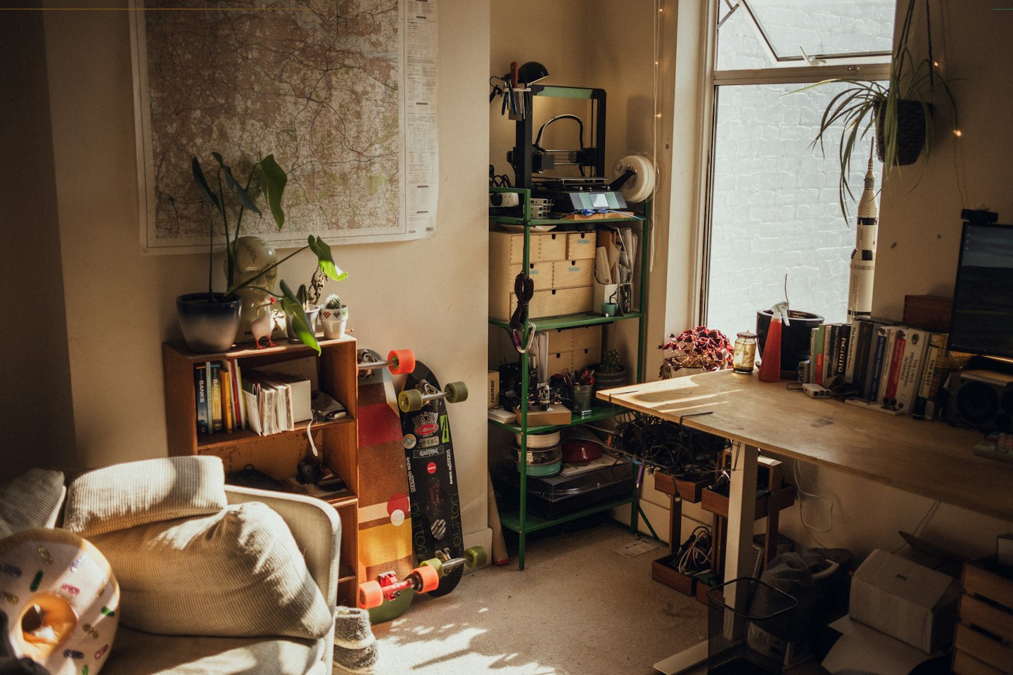 Wooden desk with 3D printer and personal items.